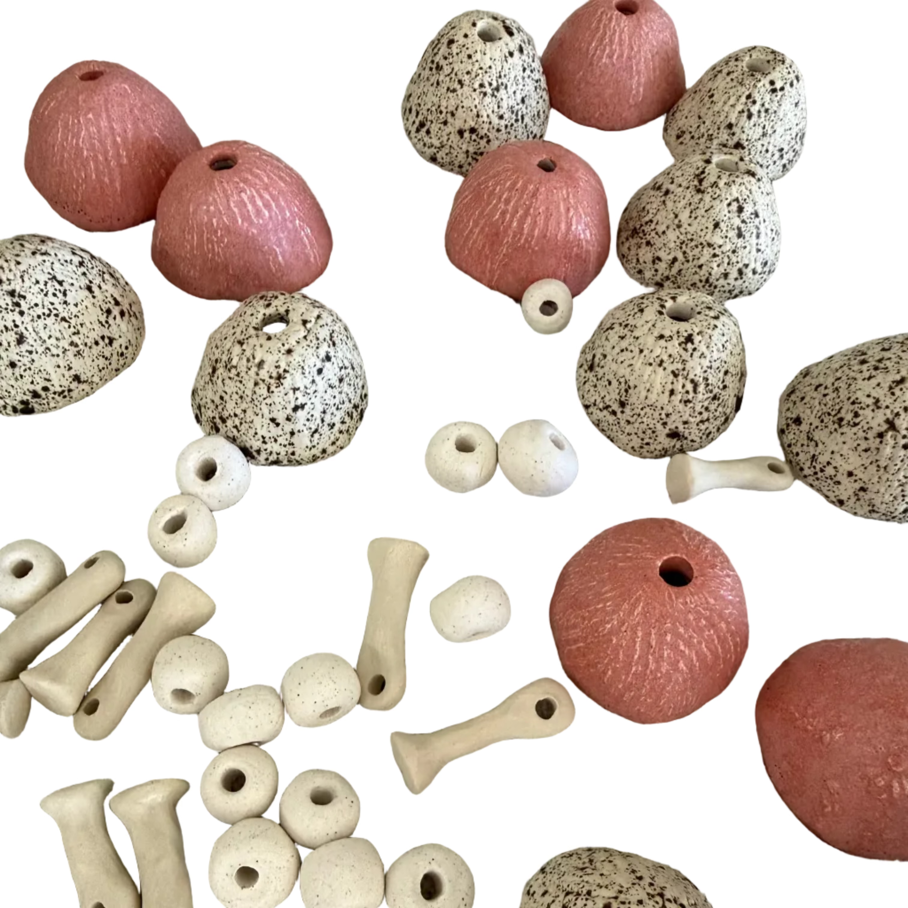 Collection of pottery toadstool beads and parts on a white background

