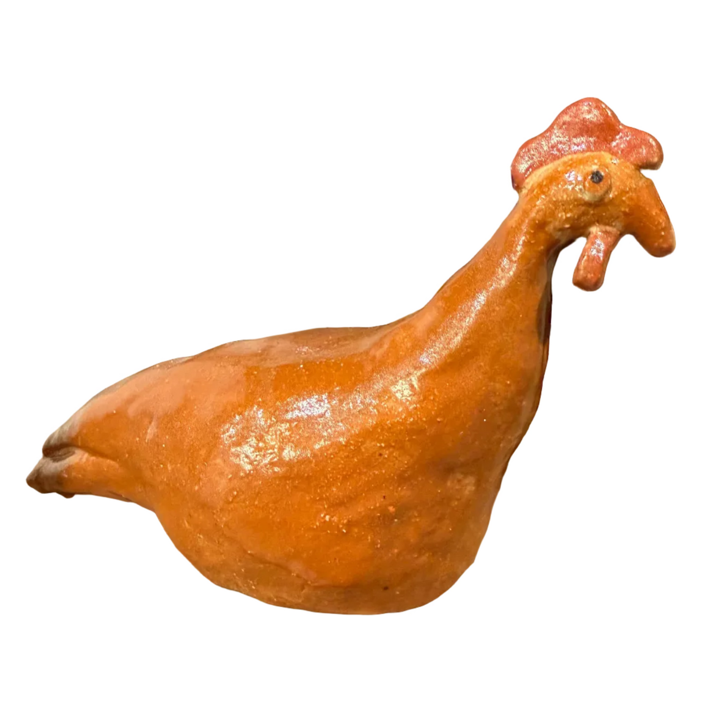 A glazed ceramic chicken figurine in terracotta orange with a red comb, displayed on a shelf among other colorful ceramic animal and animal-print decor pieces.