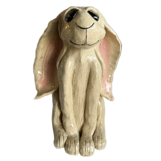 Ceramic hare figurine with a smiling expression on a white background